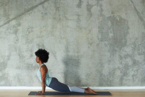 Veleisa Burrell in yoga pose upward dog